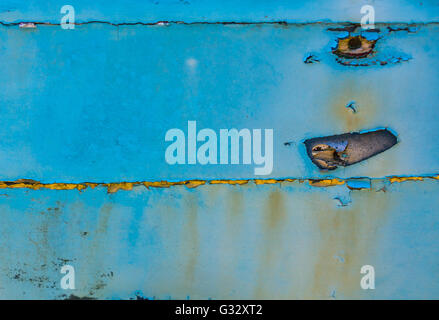 a detail image of an old wooden boat with peeling paint and signs of being exposed to the elements for years Stock Photo