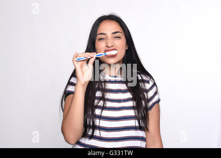 Close-up woman brushing her teeth. Isolated white background. Stock Photo