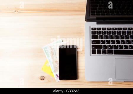 laptop, cash and smart phone. Cloud computing Stock Photo