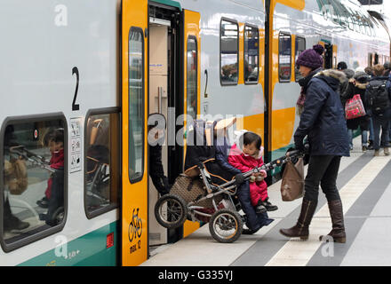 Berlin, Germany, parents raise a baby carriage in a train of ODEG Stock Photo