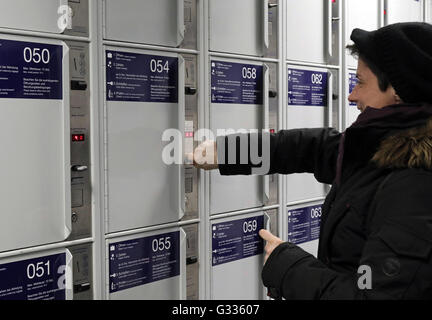 Berlin, Germany, woman completes a Bahnhofsschliessfach Stock Photo