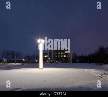 Street lamps of the office complex. Lighting supports and lamps. Winter, snow, evening. Stock Photo