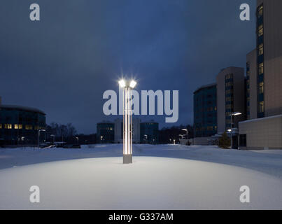 Street lamps of the office complex. Lighting supports and lamps. Winter, snow, evening. Stock Photo