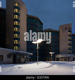 Street lamps of the office complex. Lighting supports and lamps. Winter, snow, evening. Stock Photo