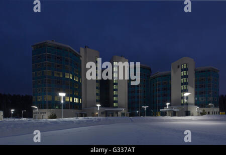 Street lamps of the office complex. Lighting supports and lamps. Winter, snow, evening. Stock Photo