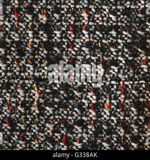 Bottle green woven woolen fabric texture. Black, white, red, yellow complicated melange. Close up fragment of the top view. Stock Photo