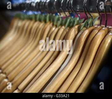 Wooden clothes hangers on a rail. Stock Photo