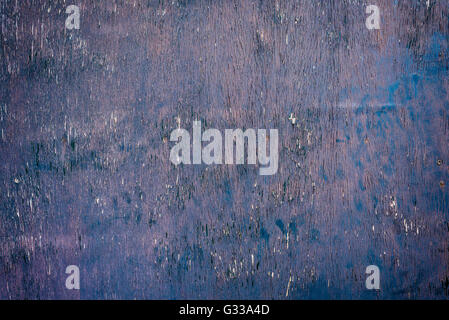 Peeling purple paint on old wooden background. Stock Photo