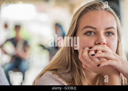 Teenager in deep thought listening to live music Stock Photo