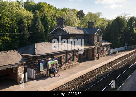 A couple waiting for a train on Delamere Railway Station , Cheshire, England, UK Stock Photo