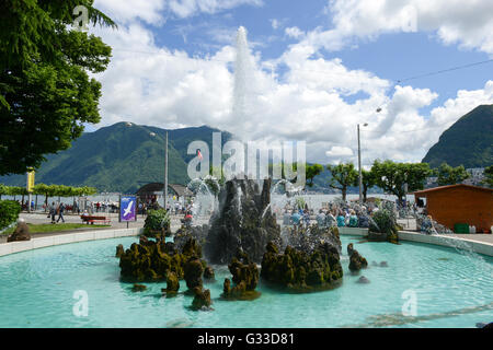 Lugano, Switzerland - 5 June 2016: people sitting and walking in front of the wonderful fountain in Lugano directly by his the l Stock Photo