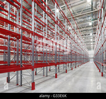 Racks pallets shelves in huge empty warehouse interior. Storage equipment. Stock Photo