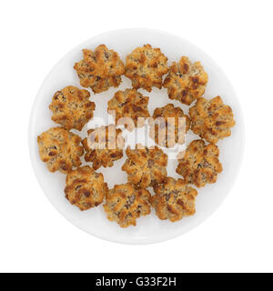 Top view of several chocolate chip macaroons on a white plate isolated on a white background. Stock Photo