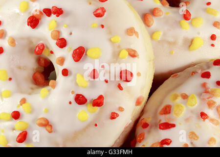 Closeup of donuts decorated with colourful sprinkles Stock Photo