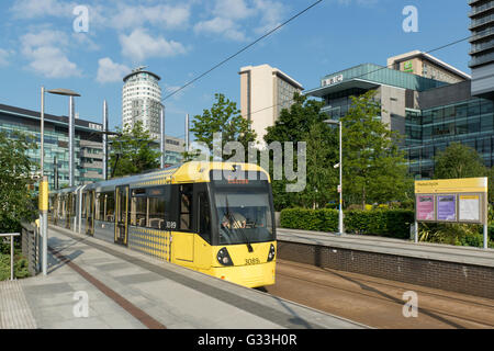A Metrolink tram pulls into the MediaCity stop at MediaCityUK in the Salford Quays area of Greater Manchester Stock Photo
