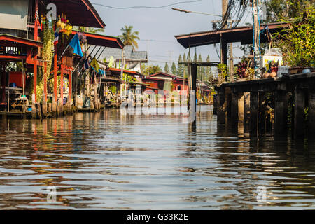 hovels of a small village on the riverside of a canal in the thai countryside in Ratchaburi district, Thailand Stock Photo