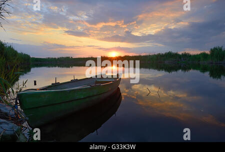 fisherman boat at sunset in summer time Stock Photo