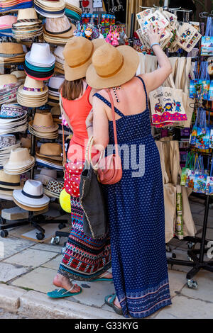 Two Young Women Shopping For Souvenirs, Corfu Old Town, Corfu, Greece Stock Photo