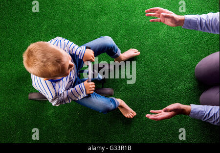 Unrecognizable father catching his son riding a bike Stock Photo