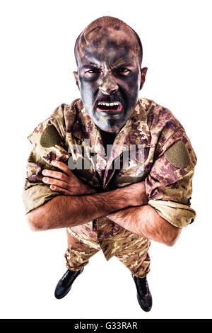 a soldier wearing camouflage clothing and army face paint isolated over a white background Stock Photo