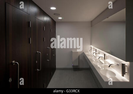 Restroom. Bathroom. WC. sinks. Wolfson College Auditorium, Oxford, United Kingdom. Architect: Berman Guedes Stretton, 2013. Stock Photo