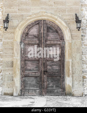 Old door or gates with lamps on the wall. Stock Photo