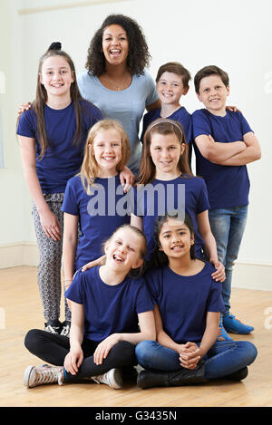 Group Of Children With Teacher Enjoying Drama Workshop Together Stock Photo