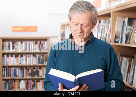 Mature Male Student Studying In Library Stock Photo