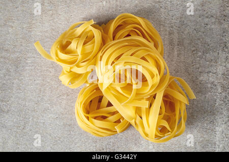 Egg pasta nest on stone table, top view Stock Photo