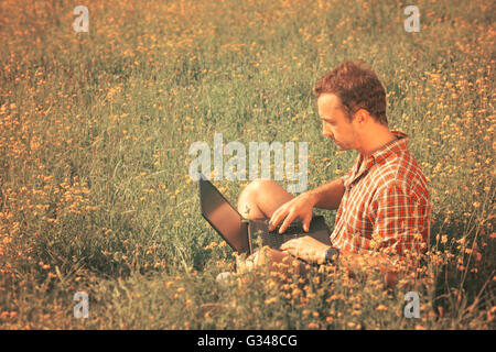 Young man with the laptop outdoor Stock Photo