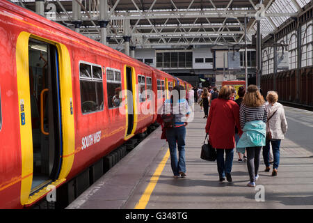 Passengers alight from a Southwest train at Waterloo Station in London Stock Photo