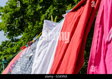 Washing drying outside on a washing line. Stock Photo