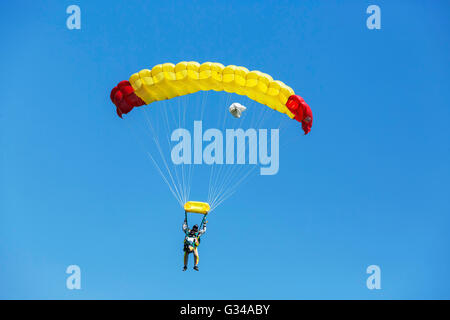 Two Skydiver with yellow parachute on blue sky. Stock Photo