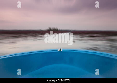 Small boat in the lake of red lotus with blur background, stock photo Stock Photo