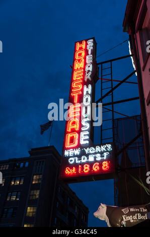 Neon sign lit up at night at the Homestead Steak House in the Meatpacking District, the oldest in New York City Stock Photo