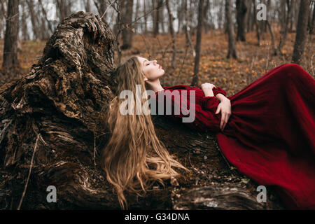 Young witch in the autumn forest Stock Photo