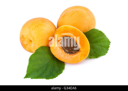 Apricots and half with fruit kernel on white. Stock Photo