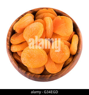 Dried apricots in wooden bowl on white background. Top view. Stock Photo