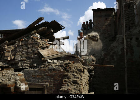 Bhaktapur, Nepal. 8th June, 2016. A Nepalese woman clears debris of her ruined home to rebuild a new one that was destroyed in last year's earthquake and tremor in Bhaktapur, Nepal on Wednesday, June 08, 2016. More than a year has passed since last year's devastating earthquake in April 25, 2015 killing more than 9,000 people. Nearly 3.5 million people were left homeless after that day. © Skanda Gautam/ZUMA Wire/Alamy Live News Stock Photo