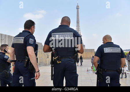 security personnel walk near the fence of a construction site at the palais du trocadero in