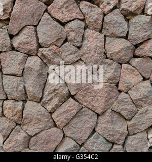 Pattern wall from red decorative stones Stock Photo