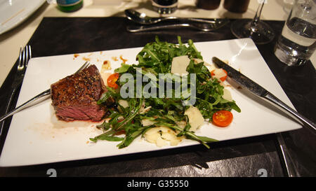 Grilled medium steaks with fresh herbs in First Class Lounge Stock Photo