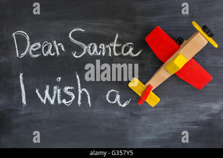 Dear Santa is written on a blackboard and christmas decoration Stock Photo