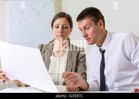 Couple of colleagues working on a project at the office Stock Photo