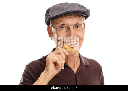 Close-up on a mature man eating a chocolate chip cookie isolated on white background Stock Photo