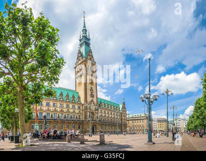 Beautiful view of famous Hamburg town hall with dramatic clouds and blue sky at market square near lake Binnenalster in Altstadt Stock Photo