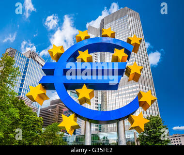 Euro sign at European Central Bank headquarters in Frankfurt, Germany with dark dramatic clouds symbolizing a financial crisis Stock Photo