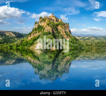 Beautiful panoramic view of historic castle on famous rock reflecting in crystal clear lake on a sunny summer day Stock Photo