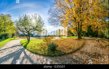 Beautiful autumn scene in famous Mirabell Gardens park in golden morning light at sunrise, Salzburg, Austria Stock Photo