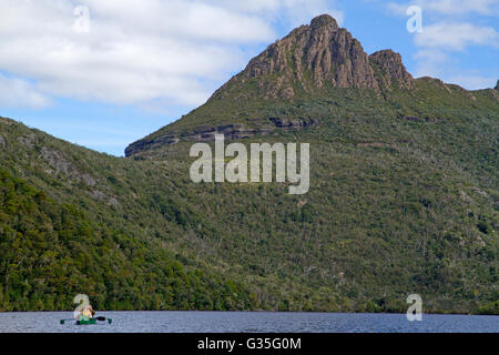 Canoeing on Dove Lake beneath Cradle Mountain Stock Photo